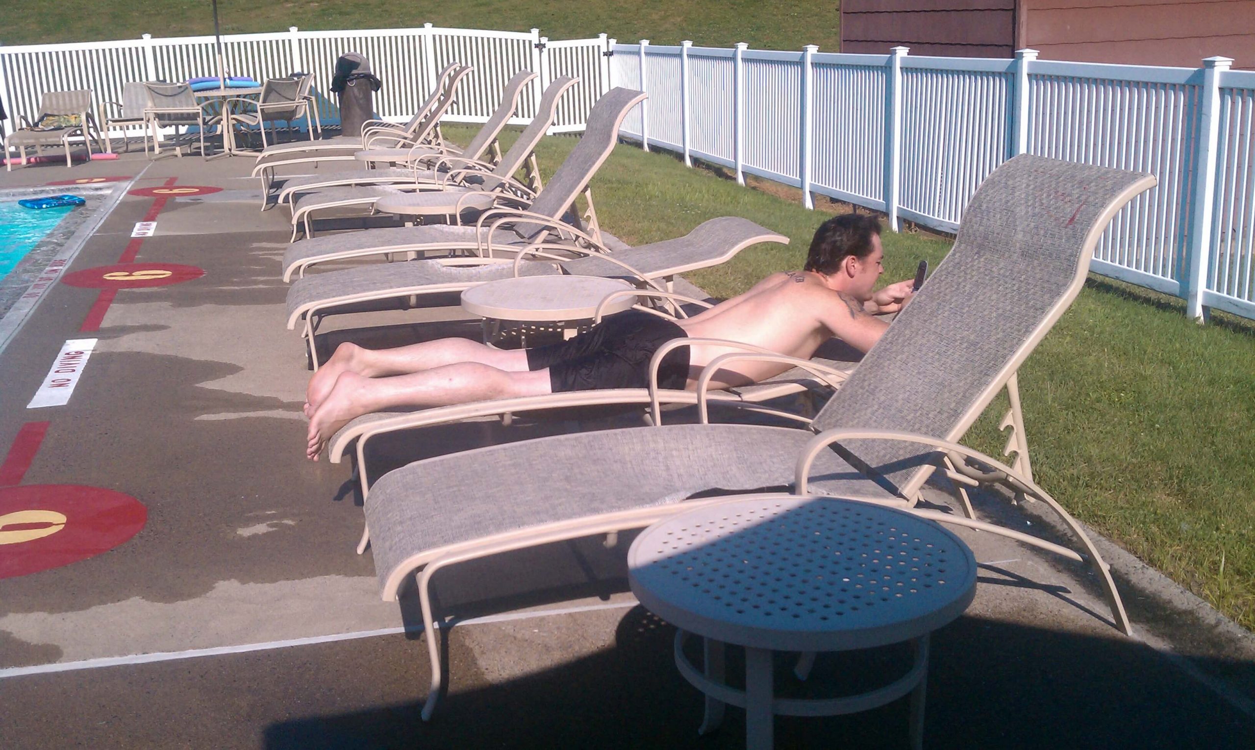 Justin catching some rays by the pool with some friends....