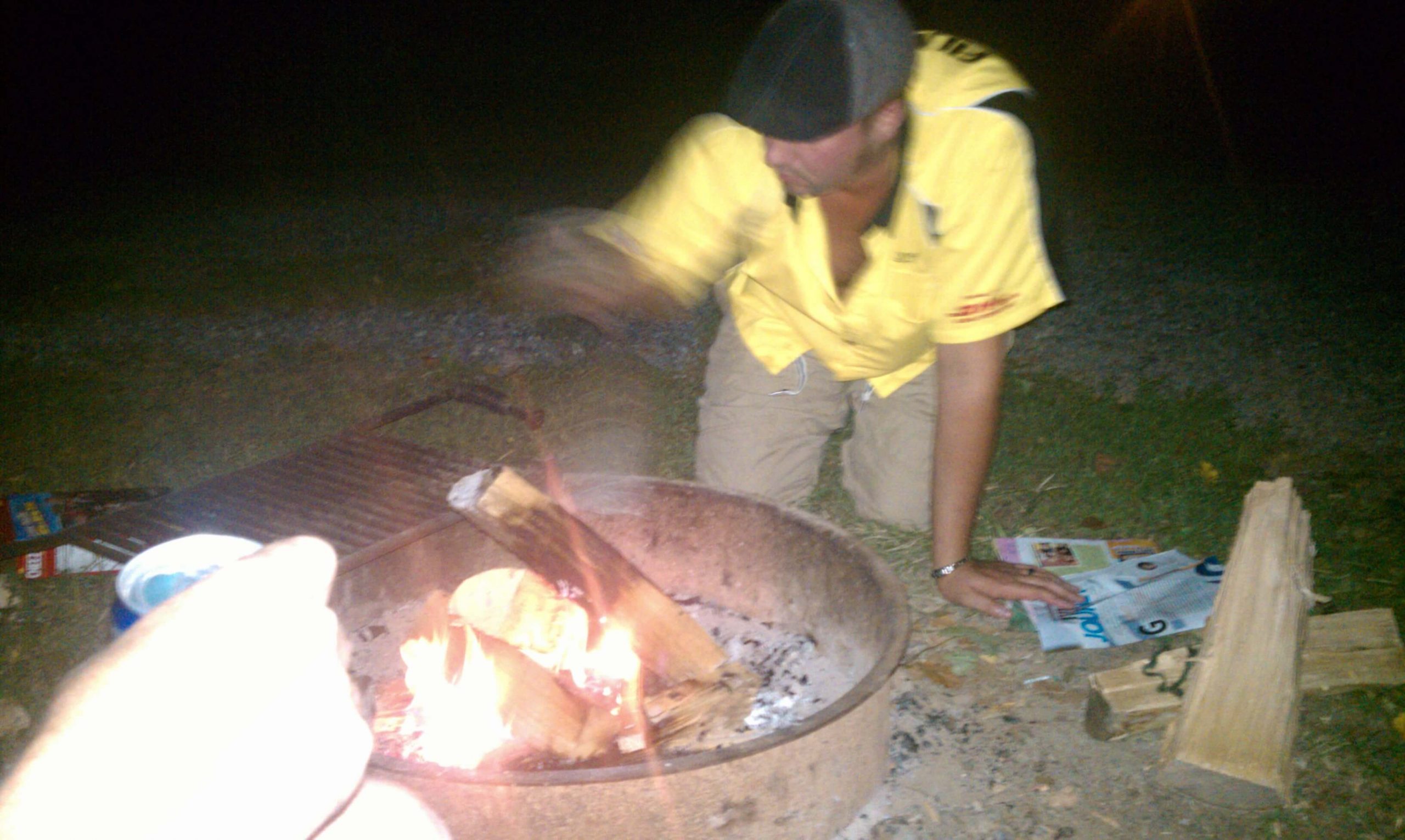 Greg building a fire.